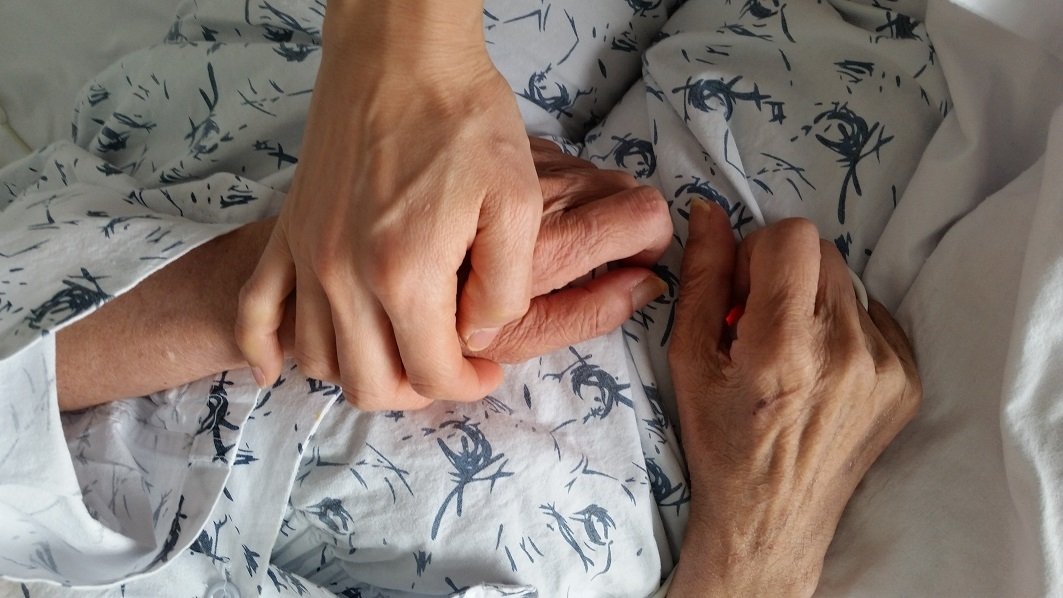 holding-elderly-family-member-s-hand-in-hospital-d-2021-10-12-14-01-24-utc